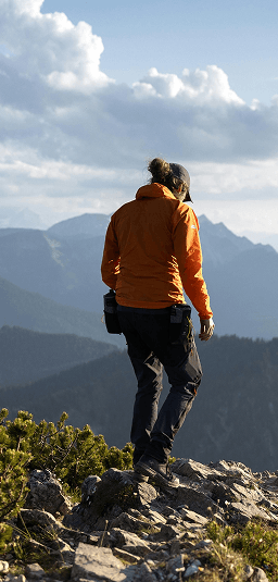 Person standing on a mountain overlook